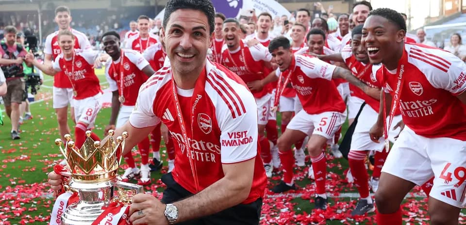Arsenal players celebrating Premier League victory with trophy