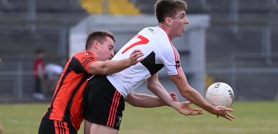 Two players competing for a ball in Gaelic football