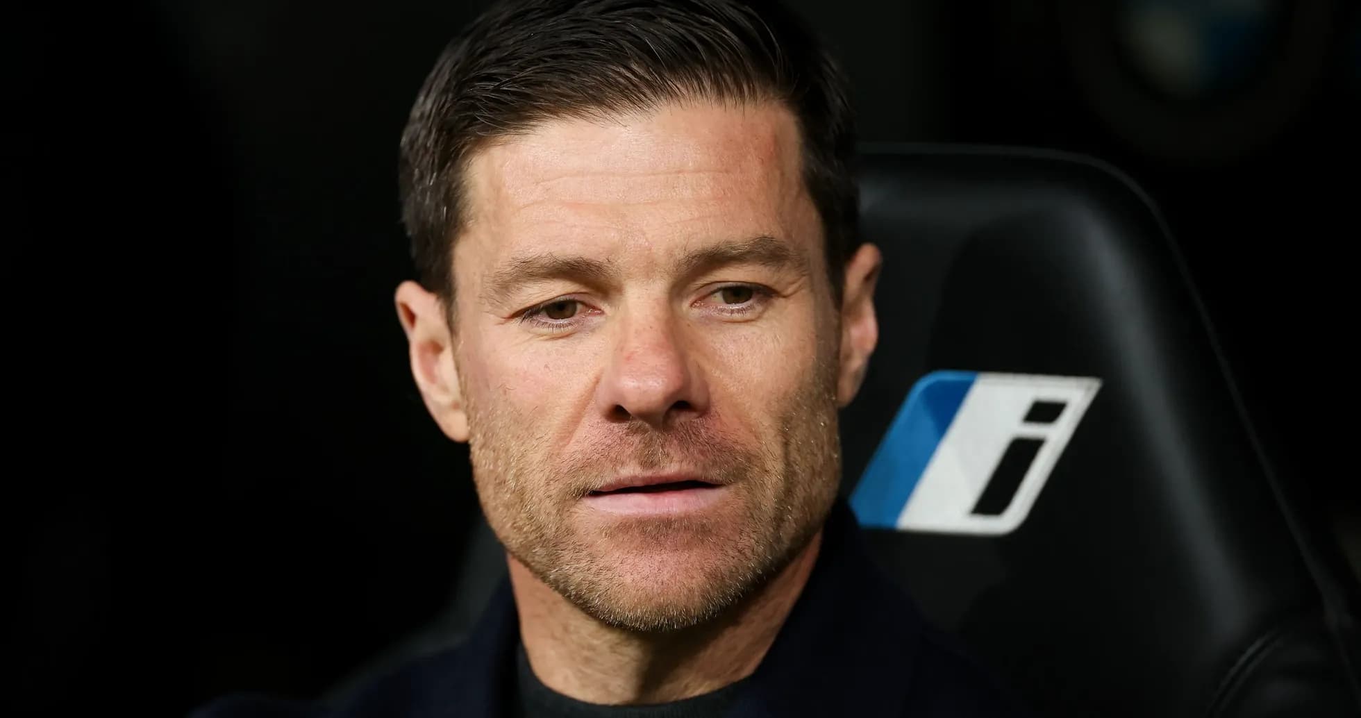 Coach sitting on bench during match