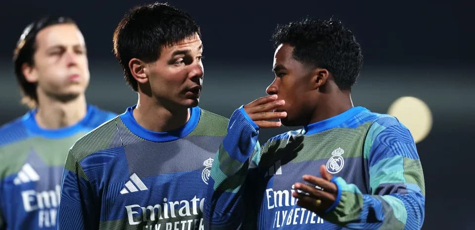 Two players in Real Madrid training discussing strategy