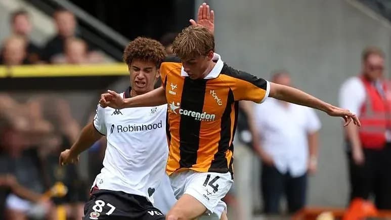 Player tackling opponent during competitive match