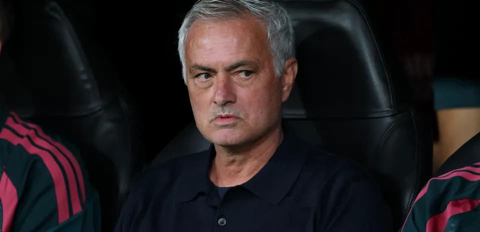 Manager sitting on bench during match