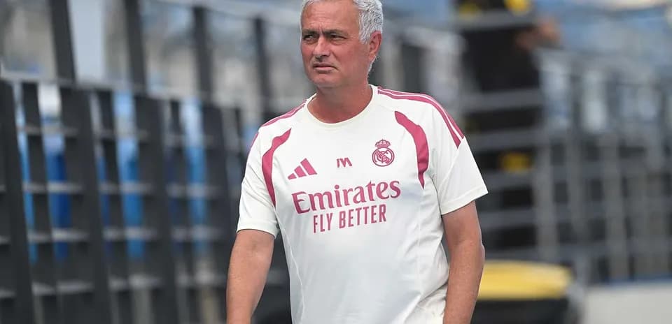 Coach in Real Madrid training kit on pitch