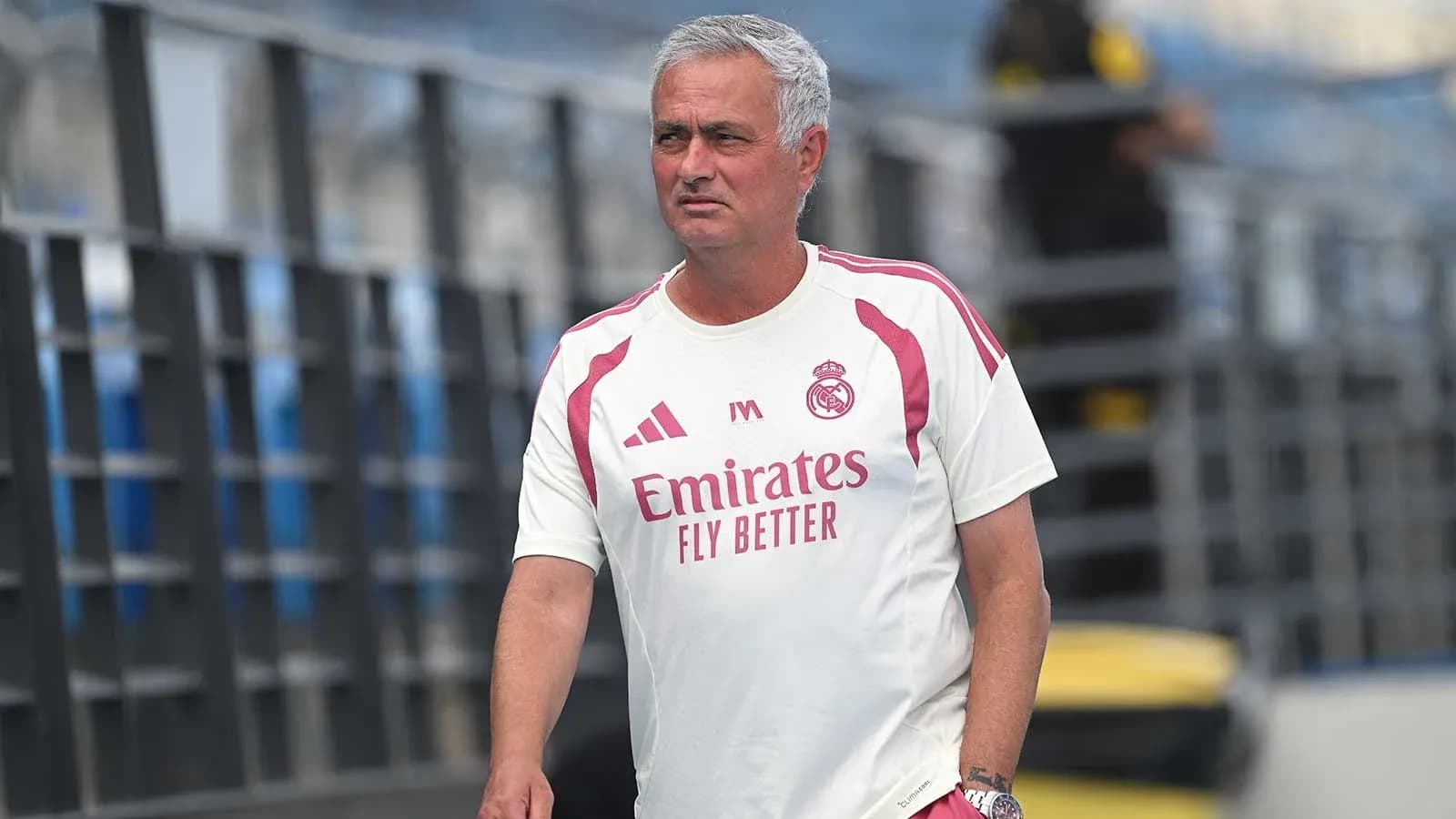 Coach in Real Madrid training kit on pitch