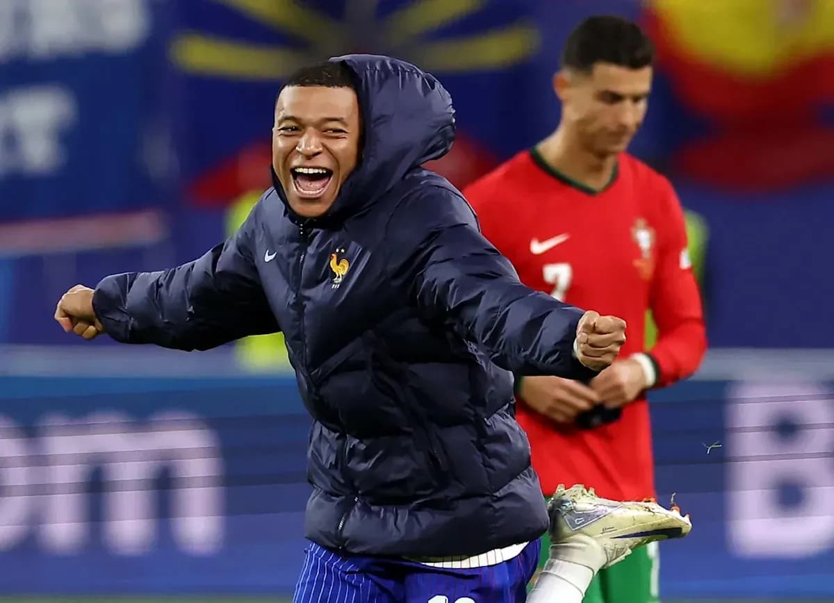 Player celebrating in a winter jacket during match