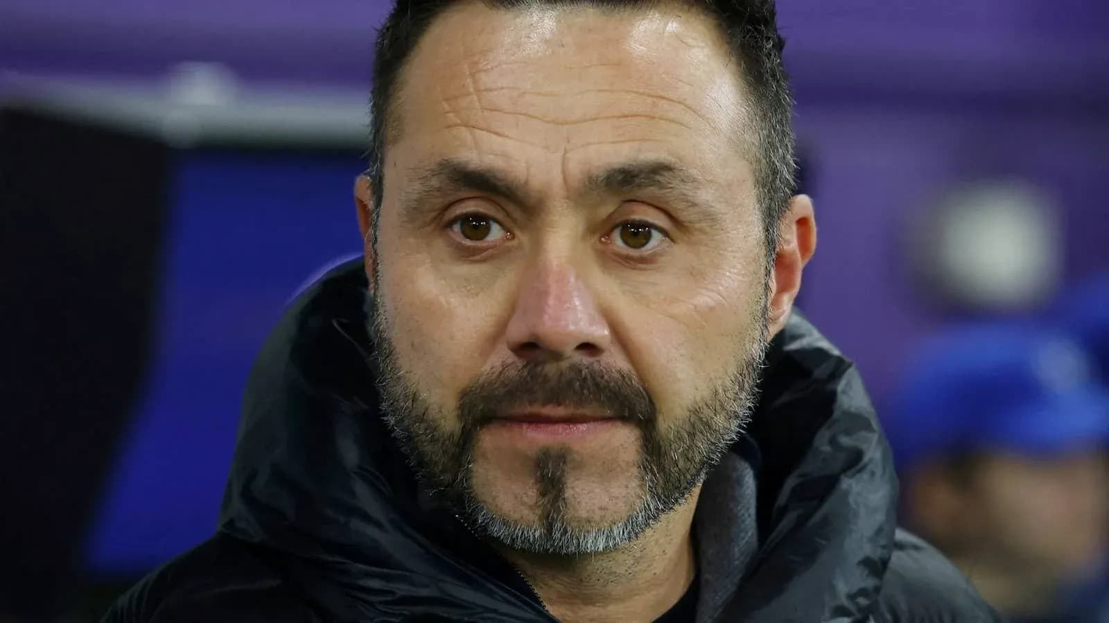 Coach observing match from the sidelines