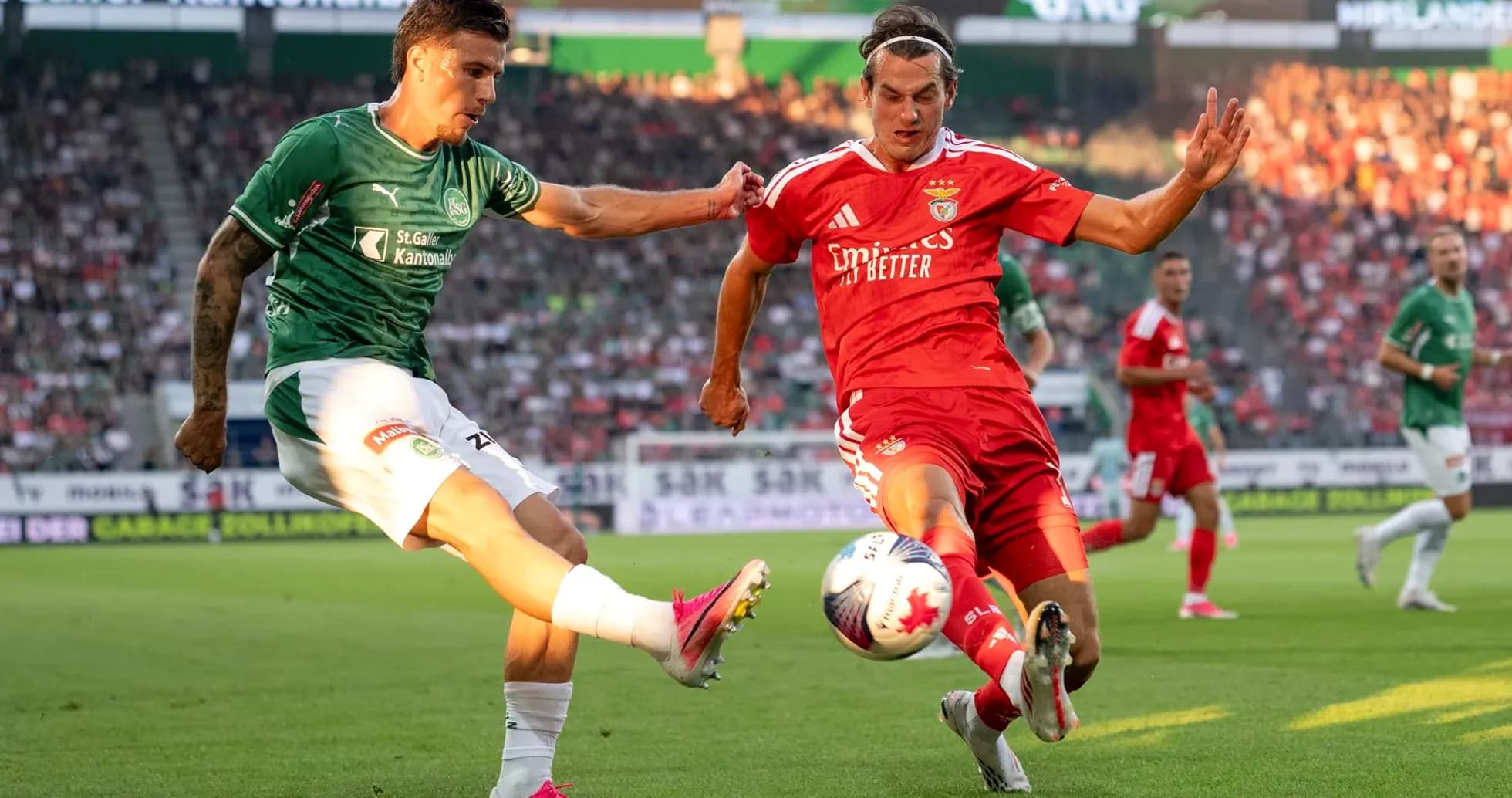 Benfica player challenging St. Gallen opponent