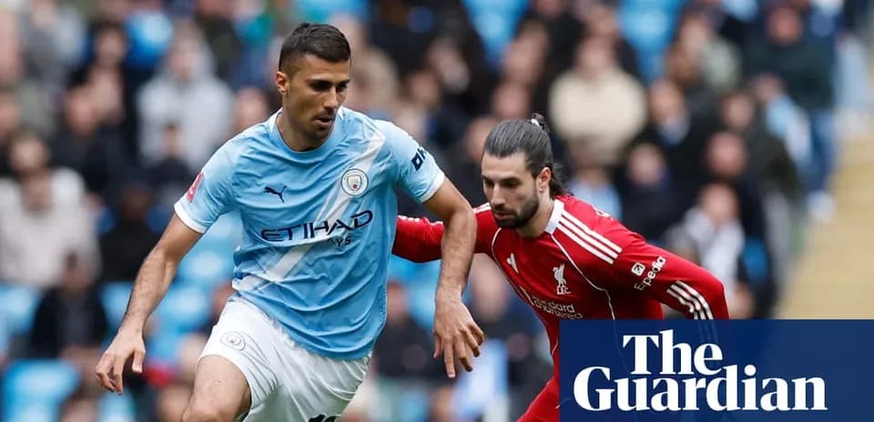 Manchester City and Liverpool players competing for the ball