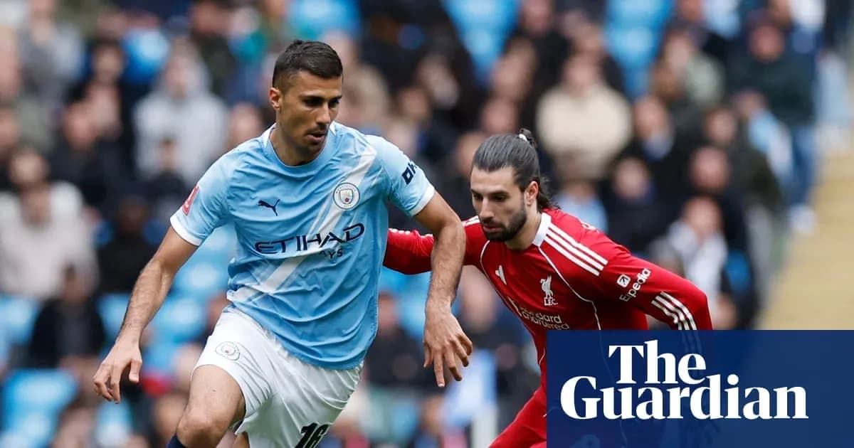 Manchester City and Liverpool players competing for the ball