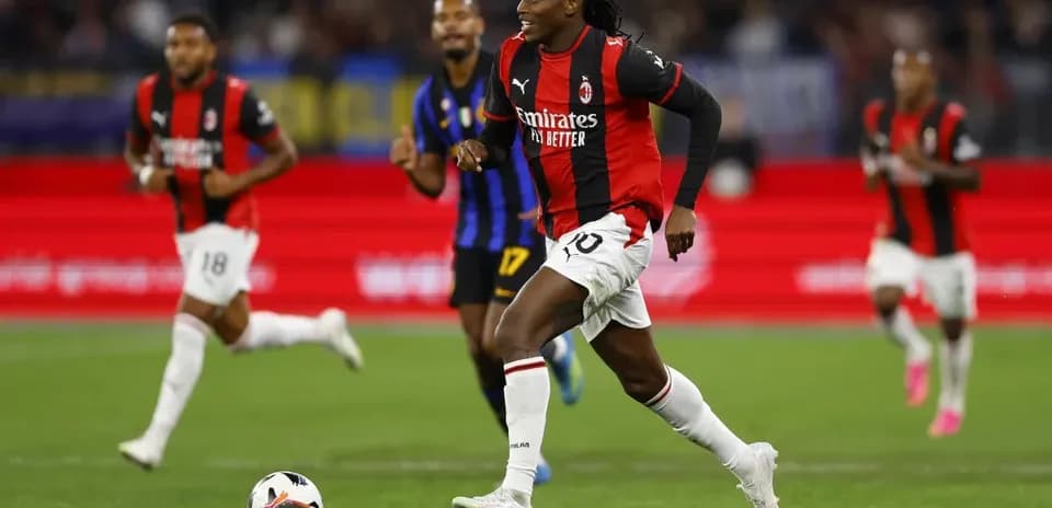 AC Milan player dribbling past opponents during match