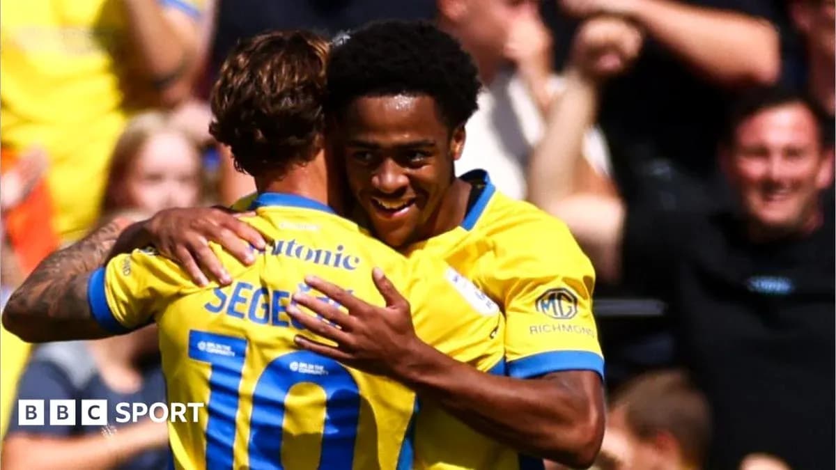 Two players celebrating a goal with embrace