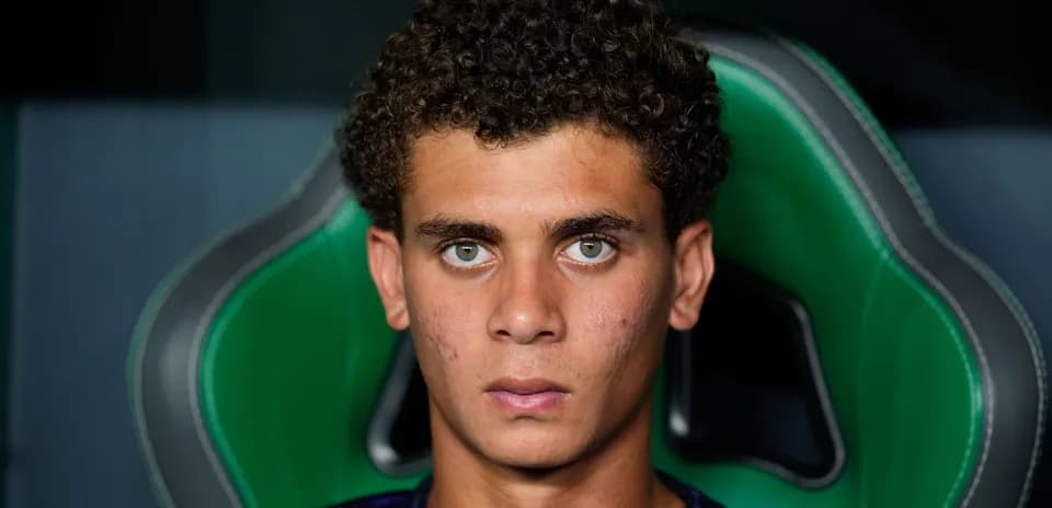Young athlete seated in green gaming chair