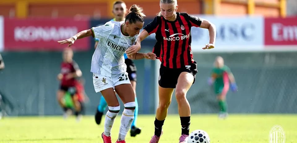 Two players competing for the ball in match
