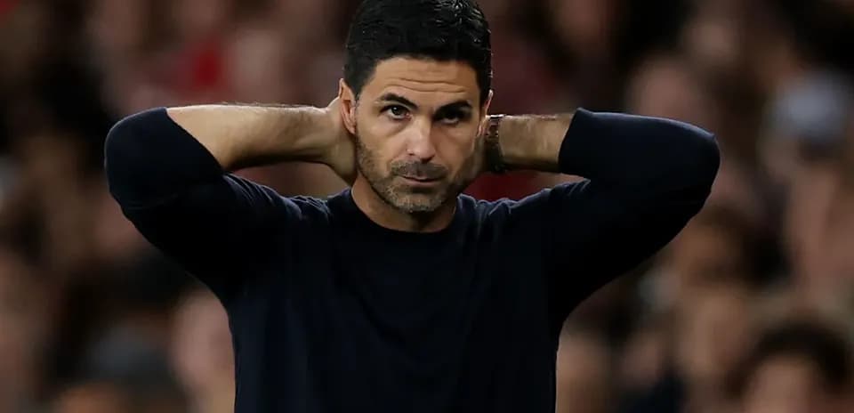 Manager with hands behind head during match