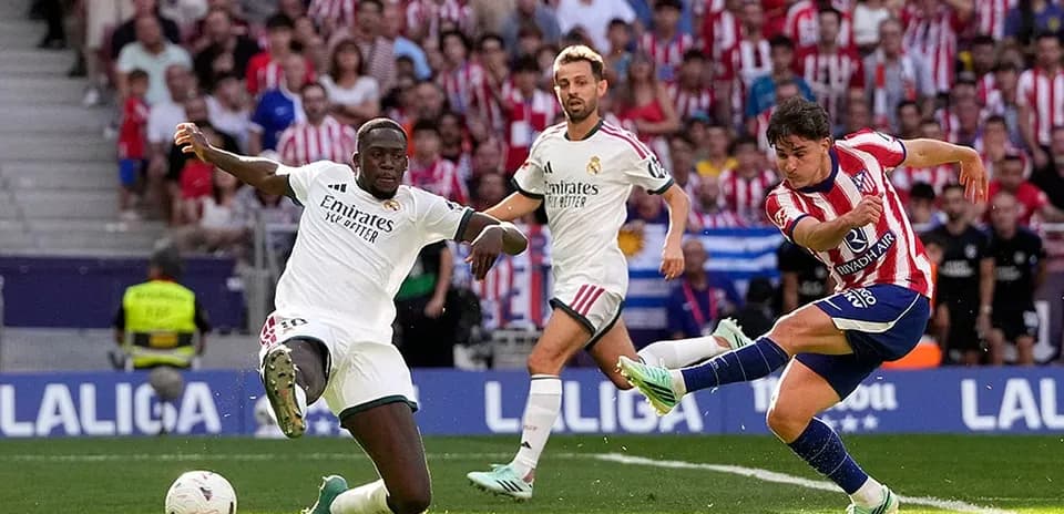 Atletico Madrid player shooting during derby match