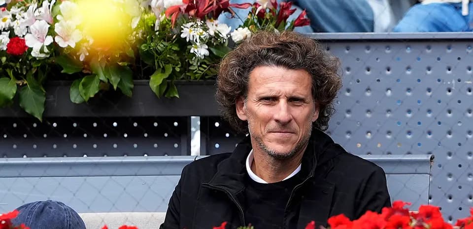 Spectator sitting in front of flower arrangements
