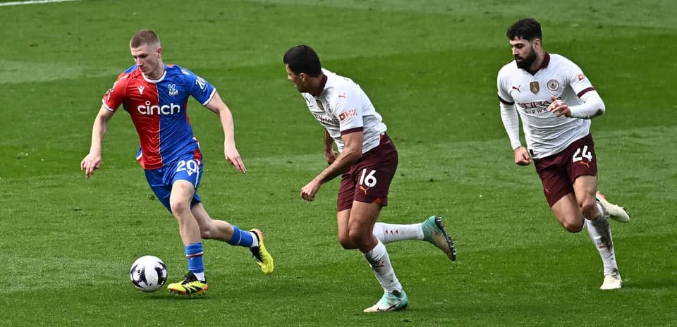 Player dribbling the ball pursued by two defenders