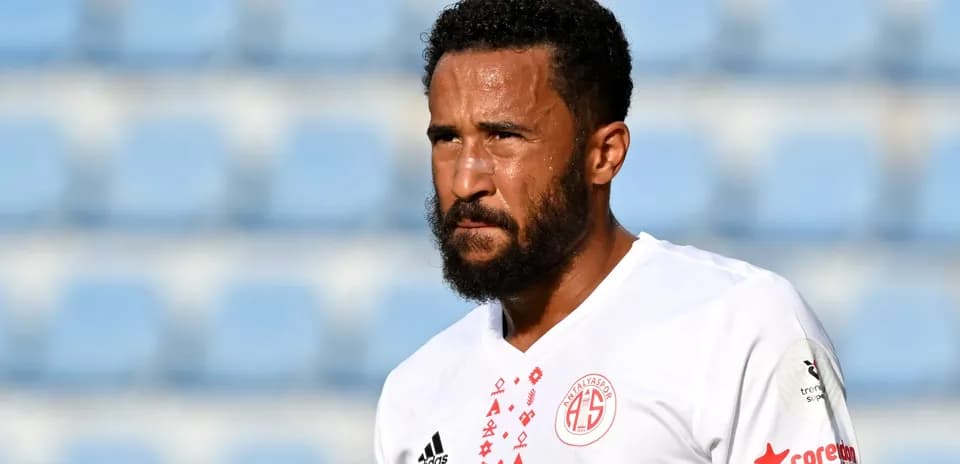 Player in white jersey during match warm-up