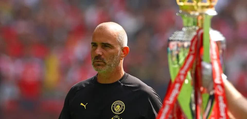 Coach observing trophy presentation before the match