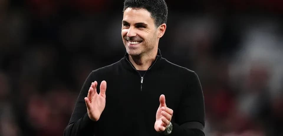 Manager clapping during a match on the sidelines