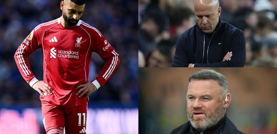Liverpool player looking down with two coaches observing