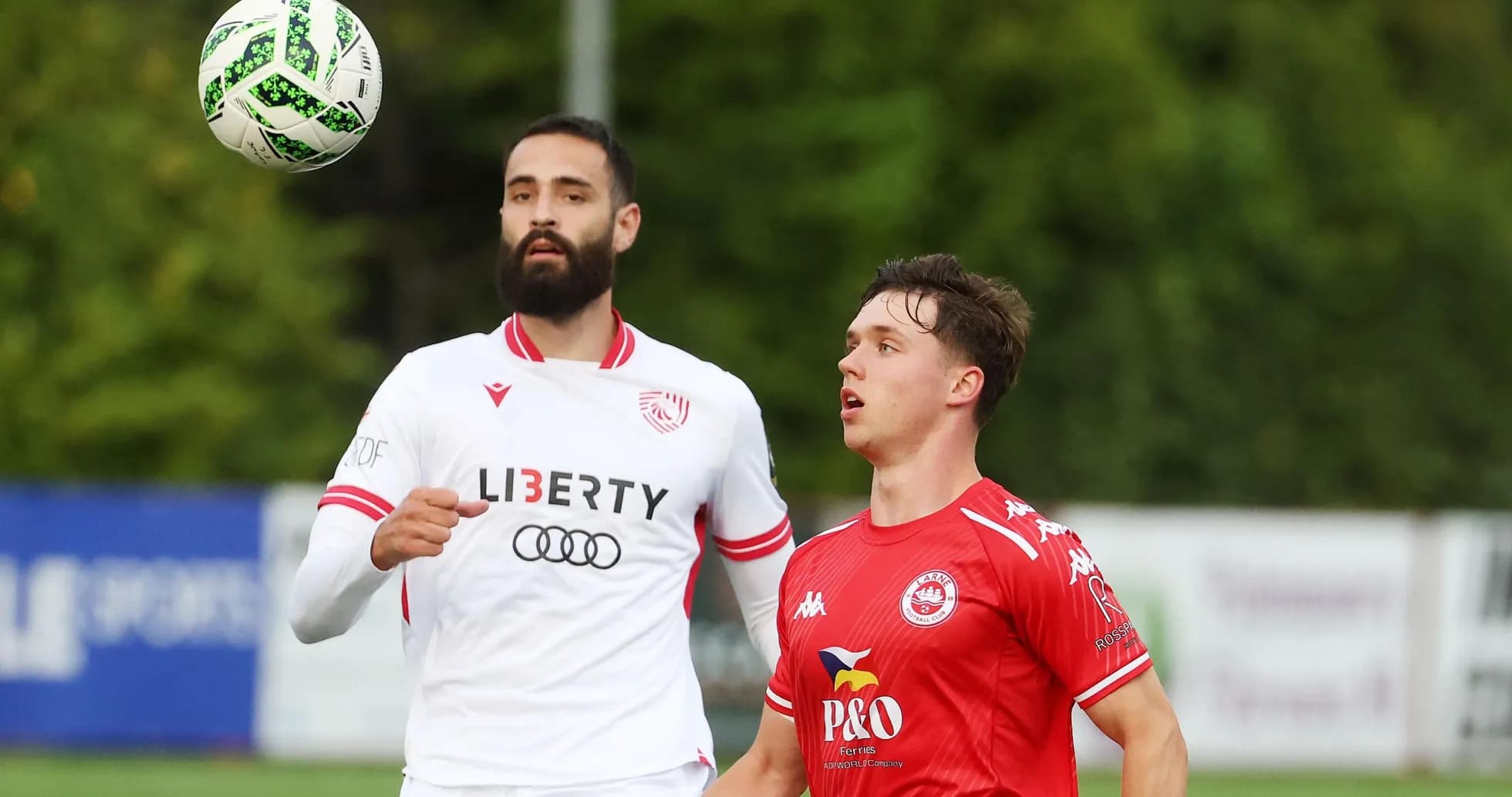 Players competing for the ball in Larne match