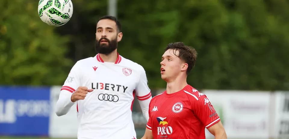Players competing for the ball in Larne match
