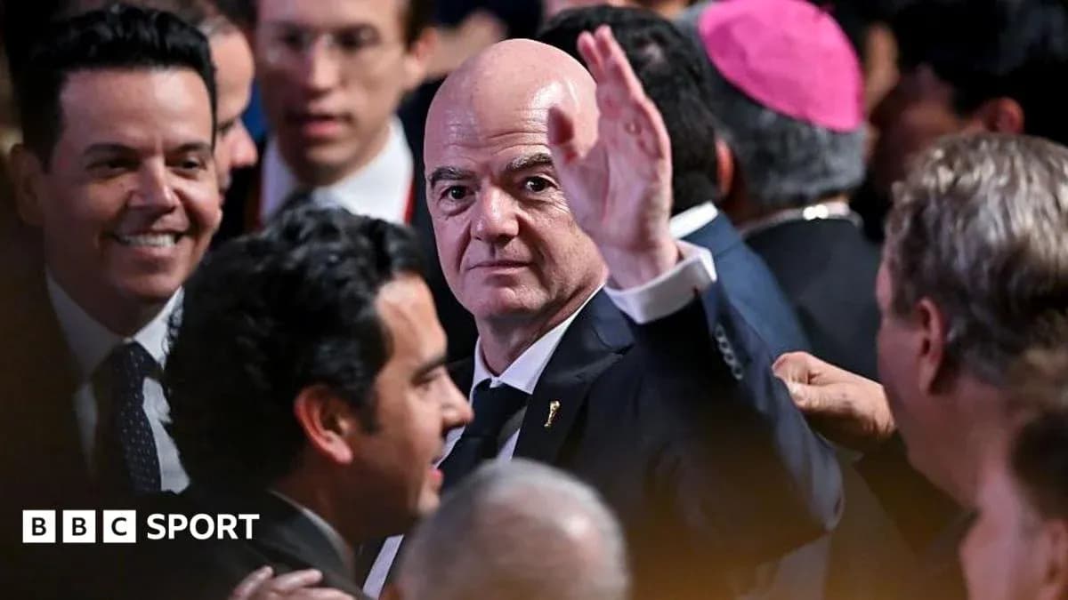 Gianni Infantino waving at an event surrounded by people