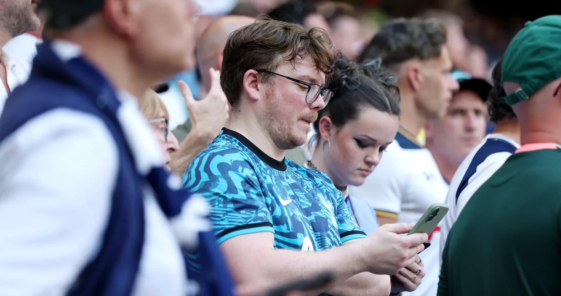 Fans focused on their phones during event