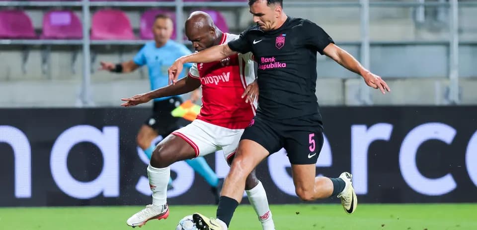 Two players competing for the ball in match
