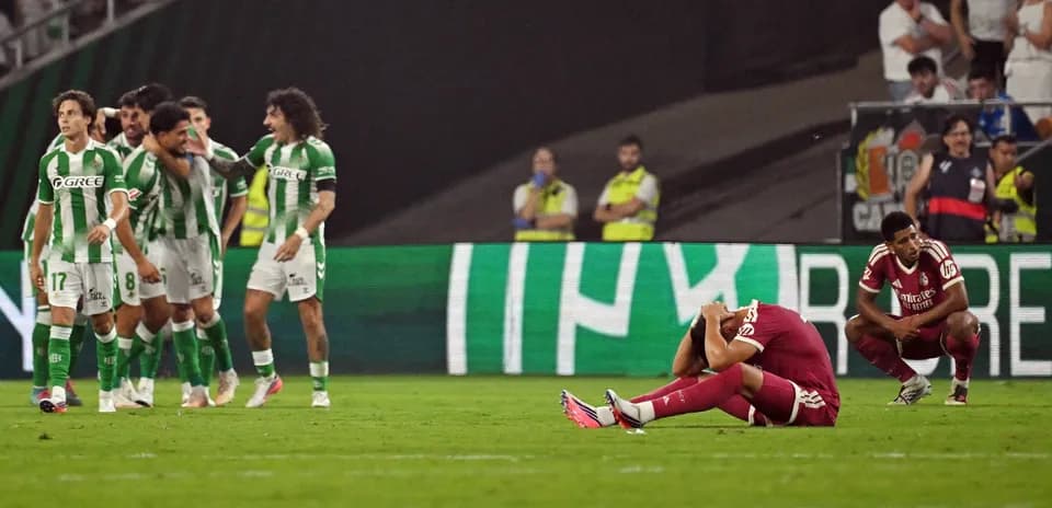 Players reacting after a match, one sitting distressed