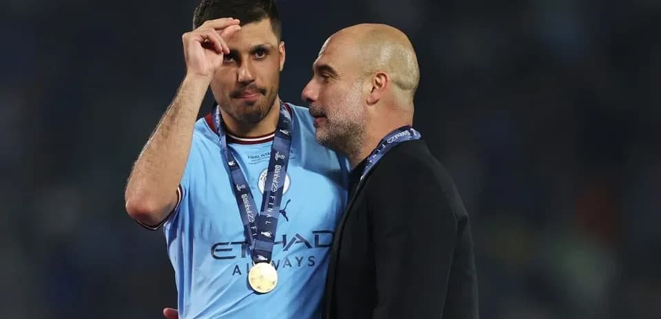 Player and coach celebrating post-match with medals