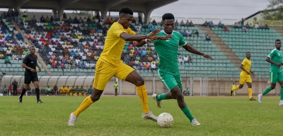 Players competing for the ball during CAF match