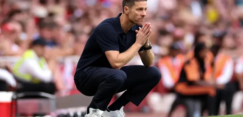 Coach crouched on sideline during match
