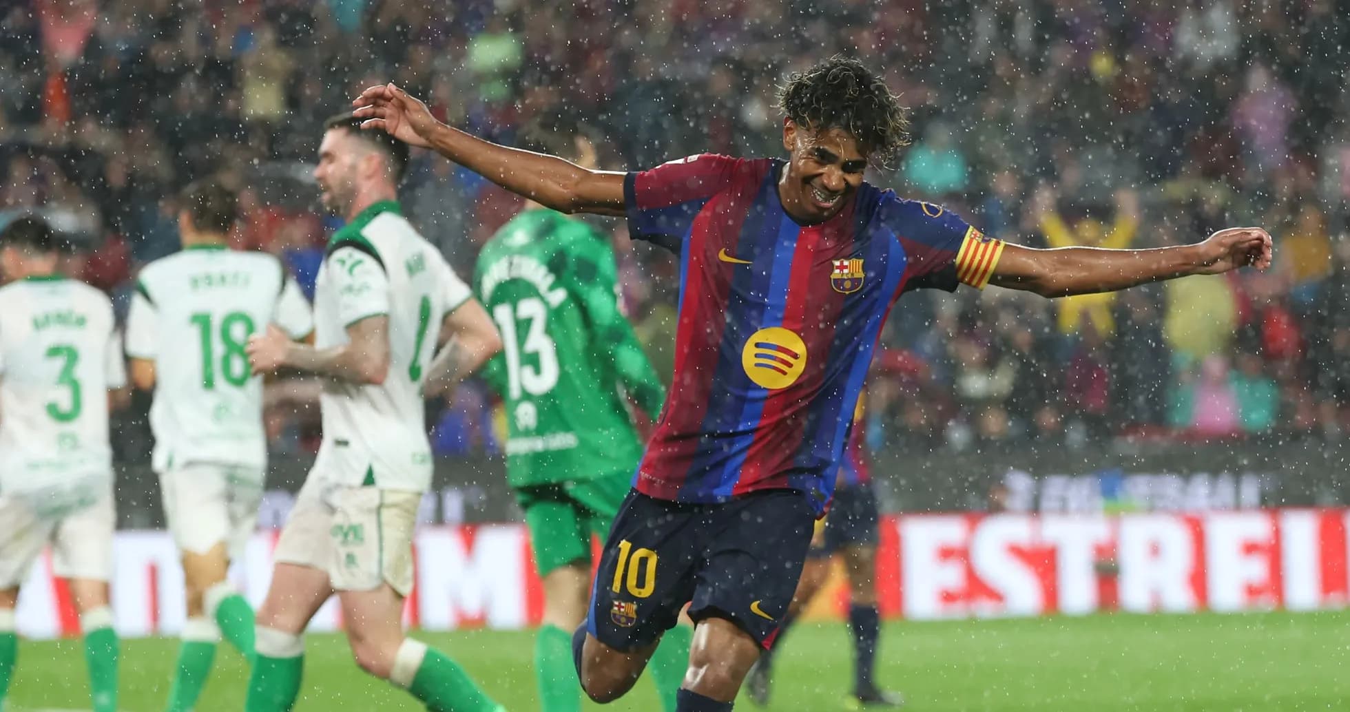 Barcelona player celebrating a goal in the rain
