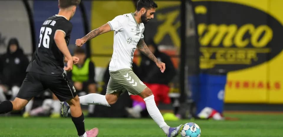 NY Cosmos player dribbling against Hartford Athletic