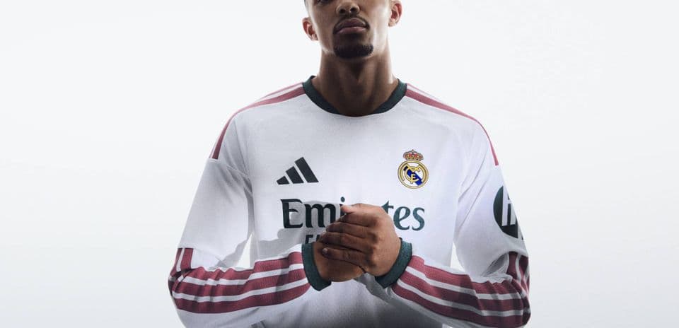 Player posing in Real Madrid jersey with hands clasped