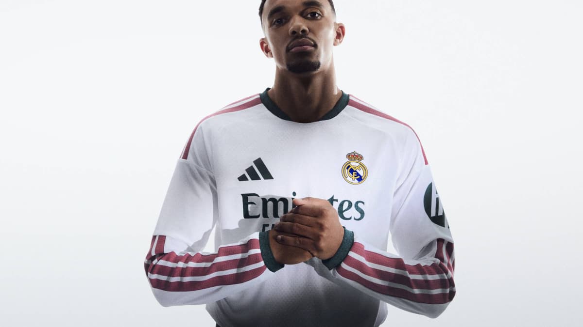 Player posing in Real Madrid jersey with hands clasped