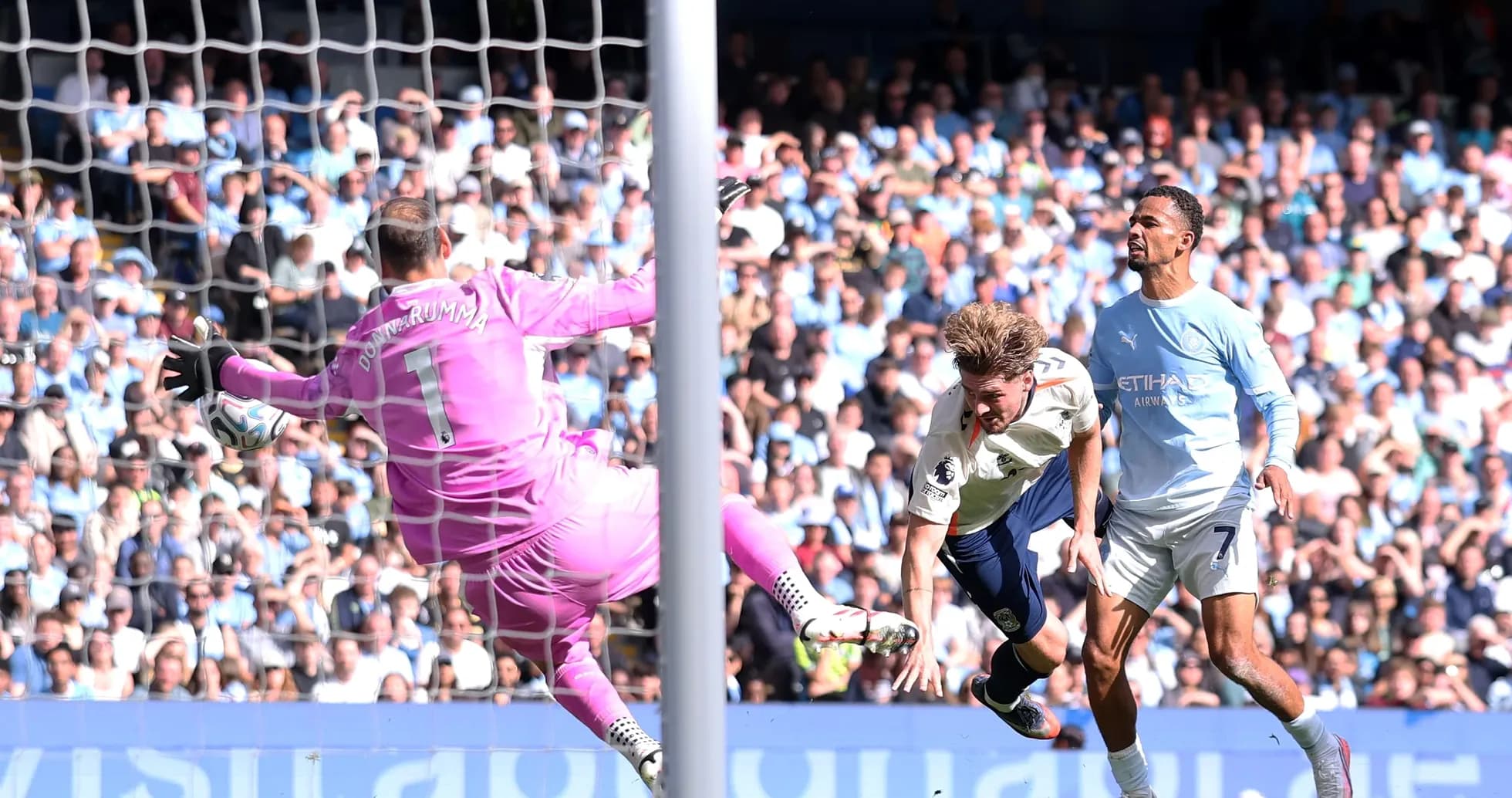 Goalkeeper attempting to save a shot on goal