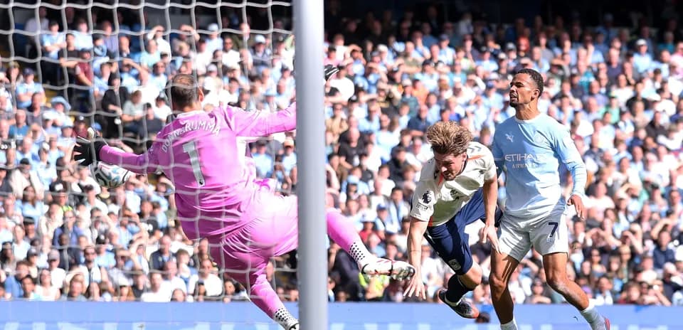 Goalkeeper attempting to save a shot on goal