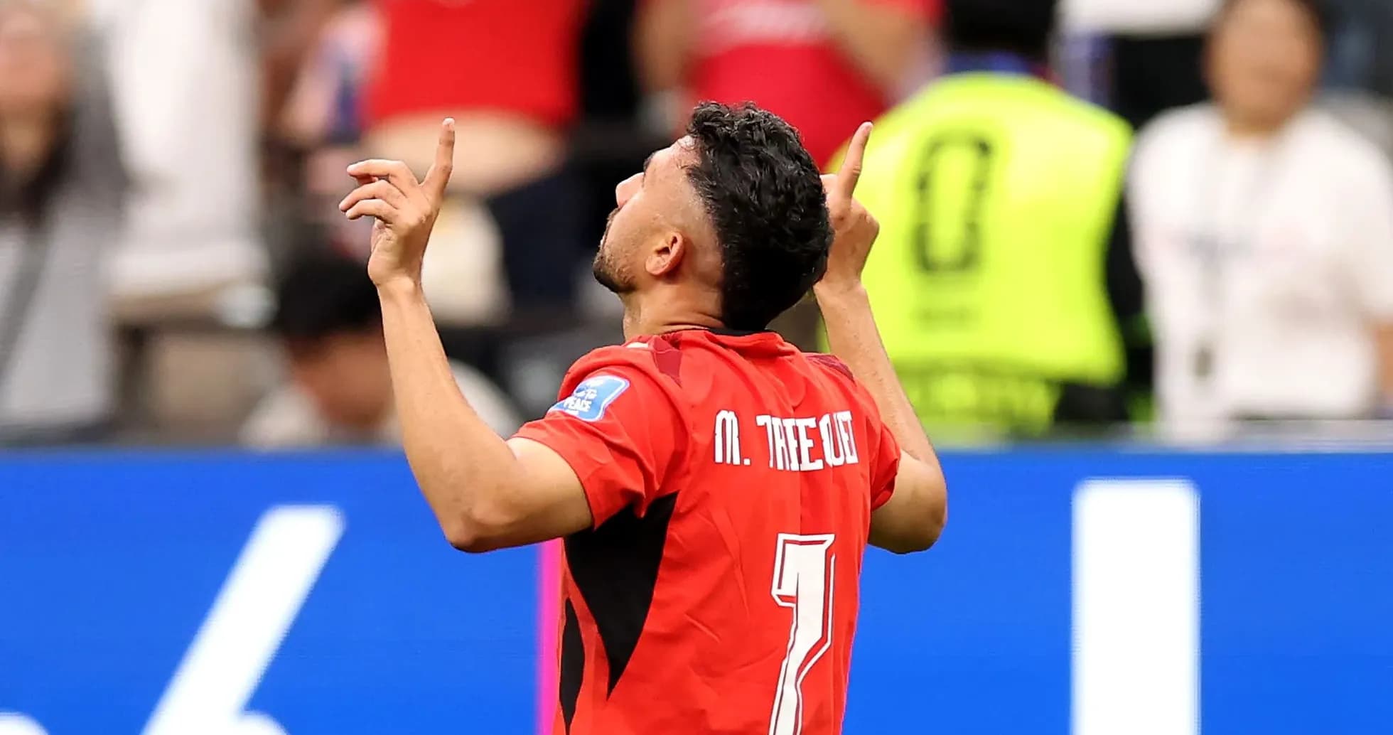 Player celebrating with arms raised during match