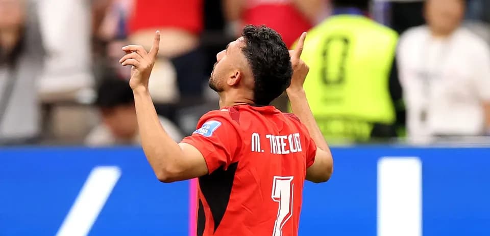 Player celebrating with arms raised during match