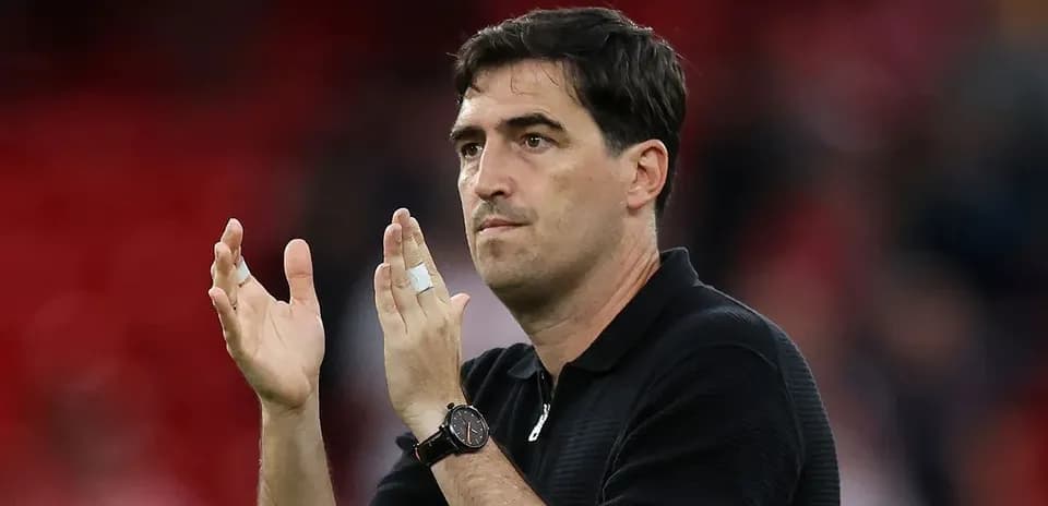 Coach applauding the crowd after the match
