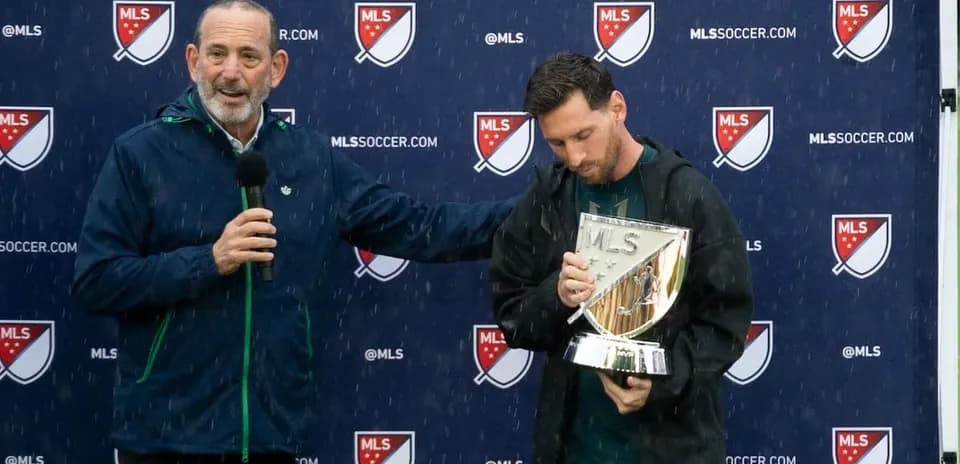 Speaker presenting trophy to player during rain