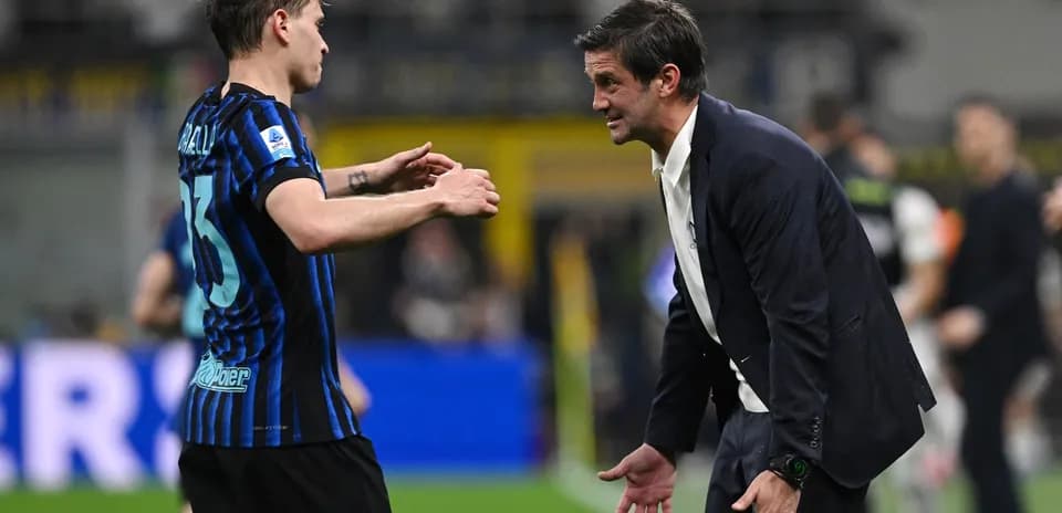 Inter player discussing with coach during match