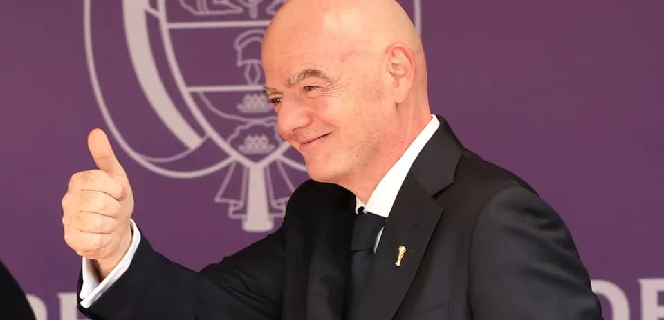 Man in suit giving a thumbs up gesture