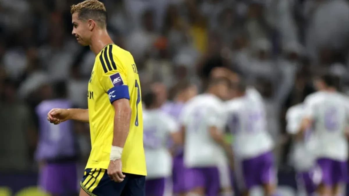 Player walking past celebrating teammates after match