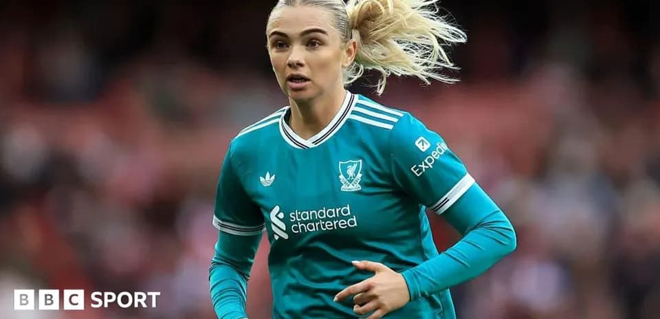 Female player running in Liverpool kit during match