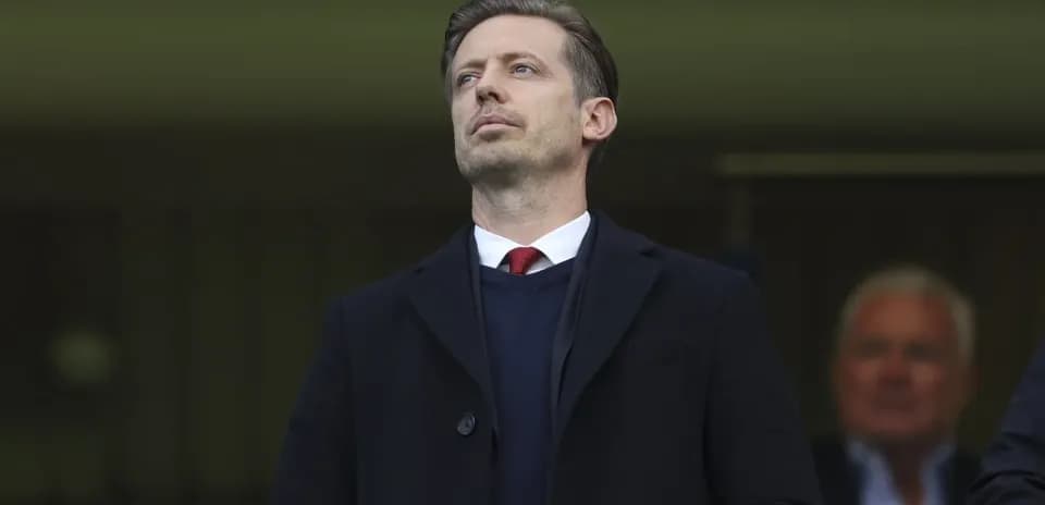Official observing from the stands during match
