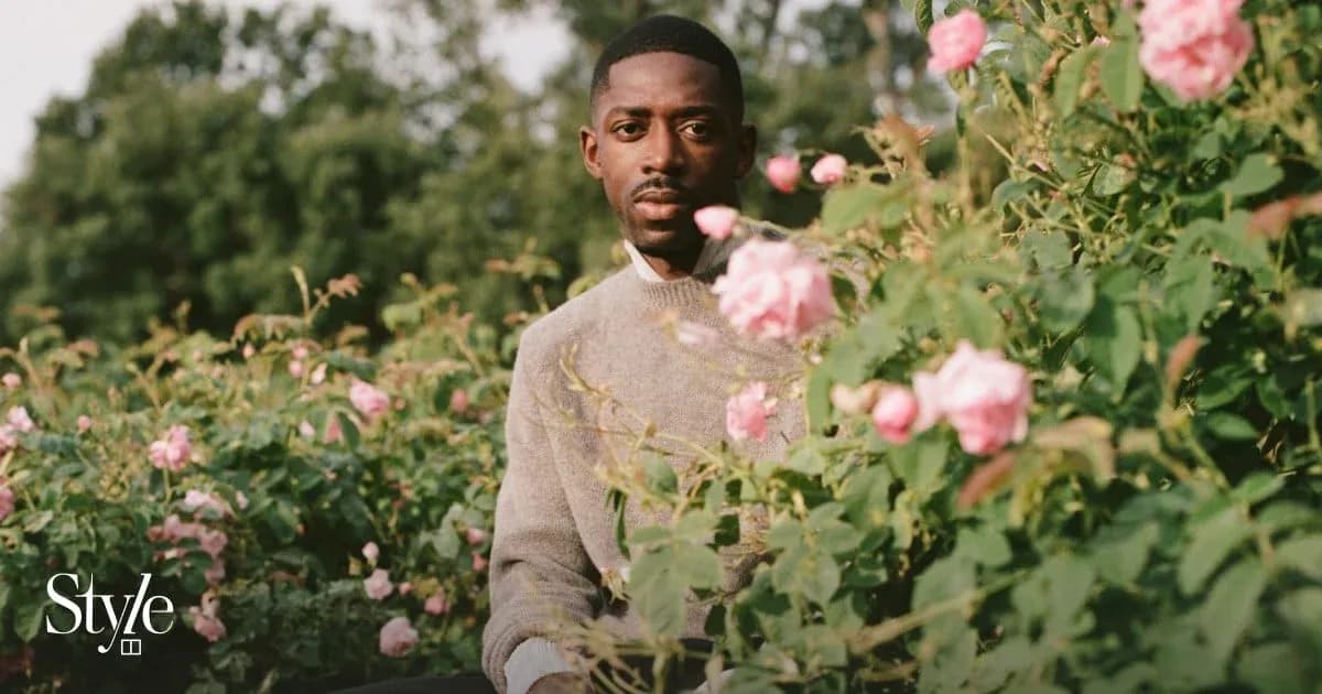 Person sitting among pink roses in garden
